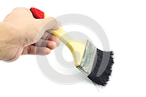 Hand holding paint brush on white background