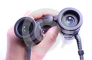 Hand holding pair of binoculars isolated on white