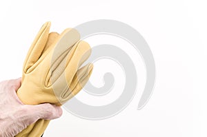 hand holding a pair of yellow leather working gloves