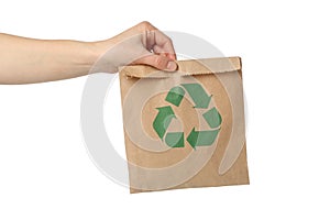 Hand holding paper bag with recycle sign, isolated