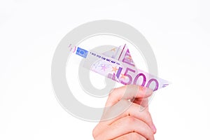 A hand holding a paper boat made with a 500 euro note