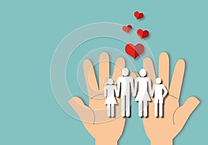 Hand holding a paper family and red heart on blue background, concept family.
