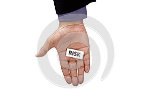 Hand holding paper with risk text