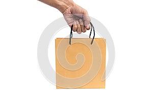 Hand holding paper shopping bag.