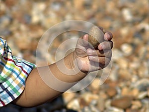 Hand holding pebble