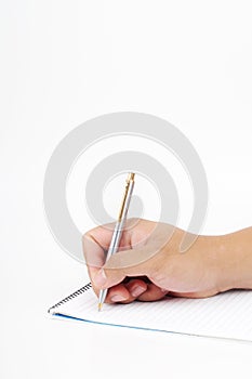 A hand holding a pen to write on a notepad