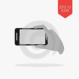 Hand holding phone for making photo icon. Flat design gray color