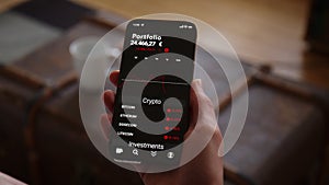 Hand holding Phone with Trading App Mockup watching Crypto Currency Investment falling in Euros
