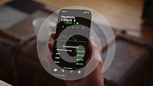 Hand holding Phone with Trading App Mockup watching Stock Market and Investments rising in Euros