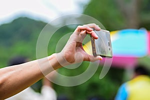 Hand holding phones, taking pictures with a smartphone