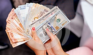 A hand holding a piece different money byr byn usd photo
