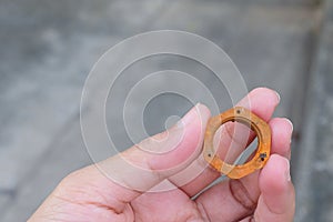 Hand Holding A Piece of Rustic Hex Nut