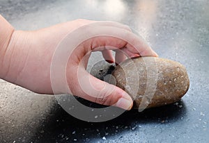 Hand Holding A Pieces of Pebble Rock