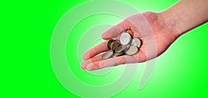 Hand holding pile of coins