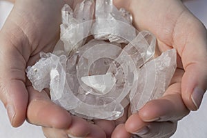 A hand holding a pile of quartz
