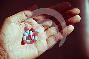 Hand holding pill capsules used for medical concept