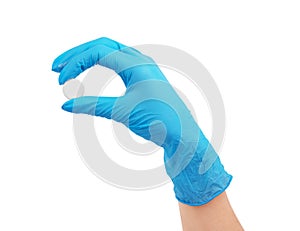 Hand holding a pill in medical gloves on a white background