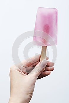 Hand holding pink lolly
