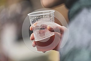 Hand Holding Plastic Beer Cup