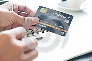 Hand holding plastic credit card. E-payment, technology and online shopping