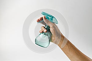 Hand holding plastic spray bottle - hold plastic spray bottle  on white. Man with water sprayer in hand