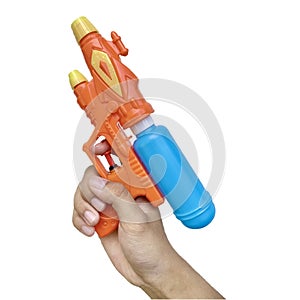 Hand holding plastic watergun toy with vibrant color of 90s