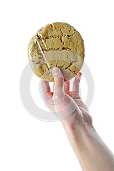 Hand holding plastic wrapped cookie