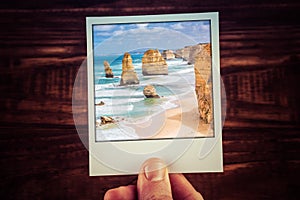 Hand holding polaroid photograph of The Twelve Apostles, Great O