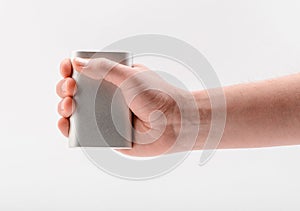 Hand holding a power bank, isolated on white