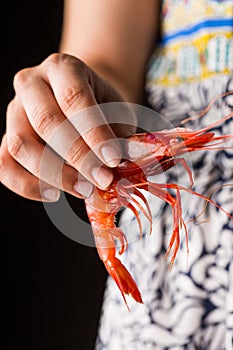 Hand holding prawn