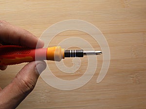 Hand holding precision screwdriver