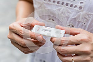 Hand holding pregnancy tester