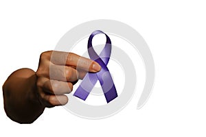 Hand holding purple ribbon on white background with copy space for text,fibromyalgia awareness, world cancer day