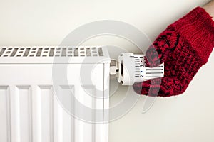 Hand holding radiator thermostat