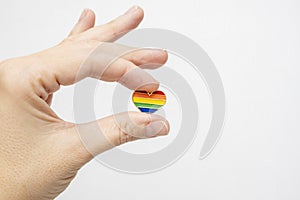 Hand holding rainbow gay pride symbol heart as lgbt rights concept, copy space