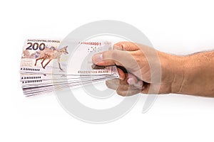 Hand holding 200 reais bills, Brazilian money, fgts concept, emergency aid portion, or economy of brazil photo