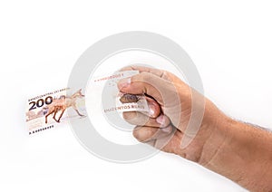 Hand holding 200 reais bills, Brazilian money, fgts concept, emergency aid portion, or economy of brazil photo