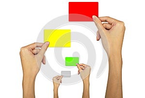 Hand holding a red card, a yellow card, a green card on a white background.