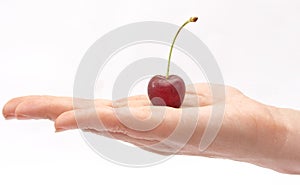 Hand holding red cherry