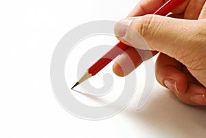 Hand holding a red pencil isolated on white paper