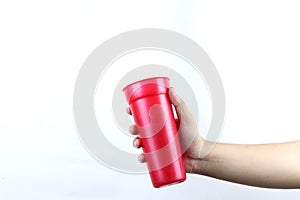 hand holding red plastic cup isolated on a white background
