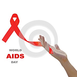 Hand holding red ribbon against white background for world AIDS day concept.