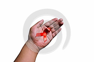 Hand holding red ribbon. Aids Awareness Sign Red Ribbon for World Aids Day concept . World Aids Day symbol for Aids campaigne -