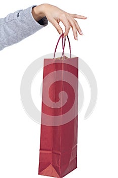 Hand holding a red shopping bag