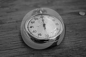 Hand holding retro stopwatch in black white