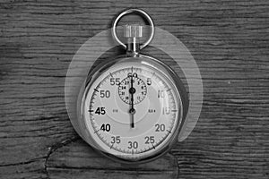 Hand holding retro stopwatch in black white