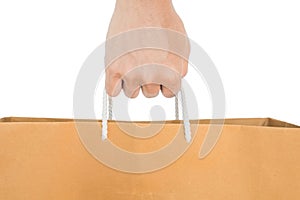 Hand holding reuse paper bag, isolated on white background