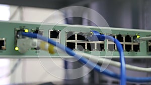 Hand holding RJ45 or Cat5 connect to ethernet switches