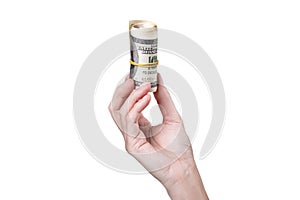 A hand holding a roll of money isolated on