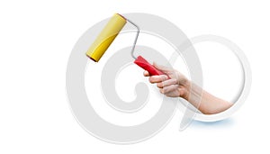 The hand holding the roller for pasting .